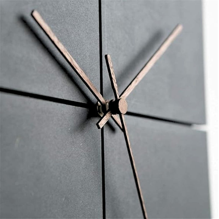 black minimalist Nordic clock closeup brown hands